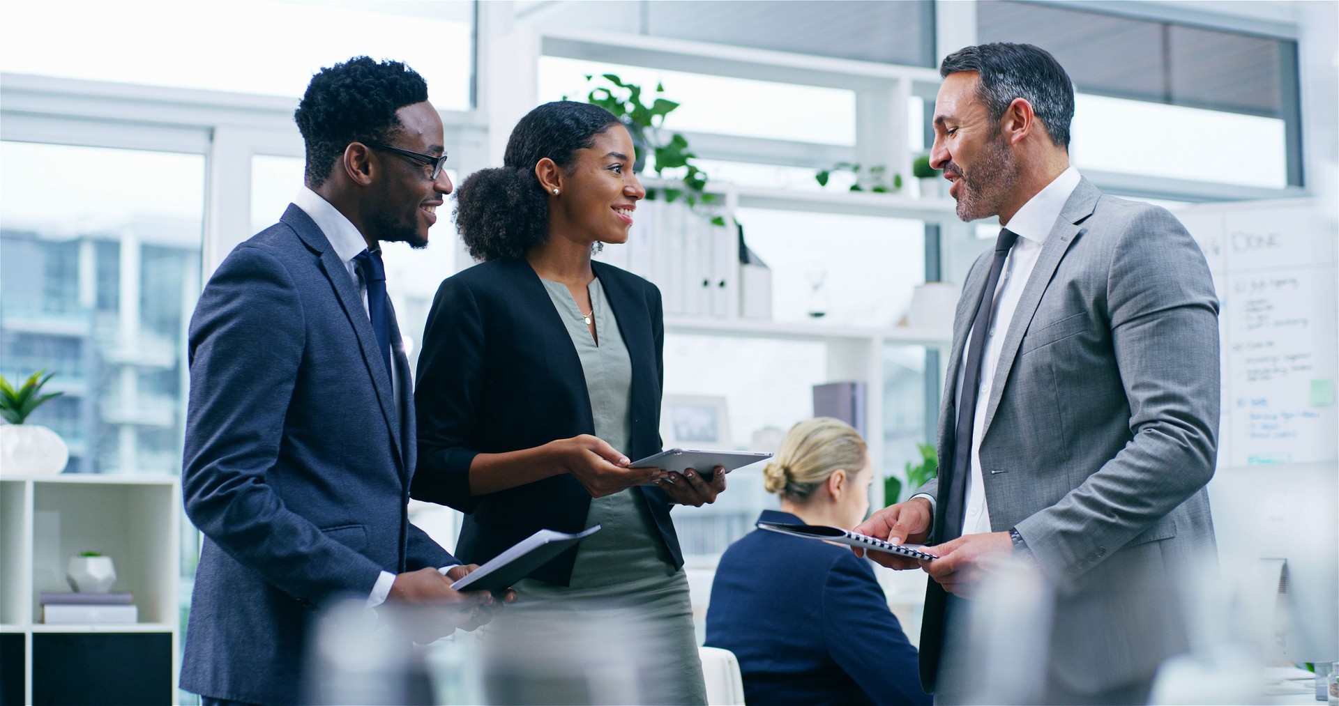 Conversation, documents and business people in meeting, finance and coworking in modern office. Employees, staff and accounting firm with support, advice and mentor with feedback and review budget